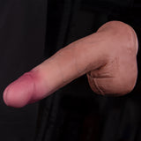 A hand is pointing towards something against a dark background.