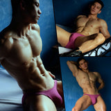 Muscular man posing in tight purple briefs, showcasing Kenvin replica dildo bulge.