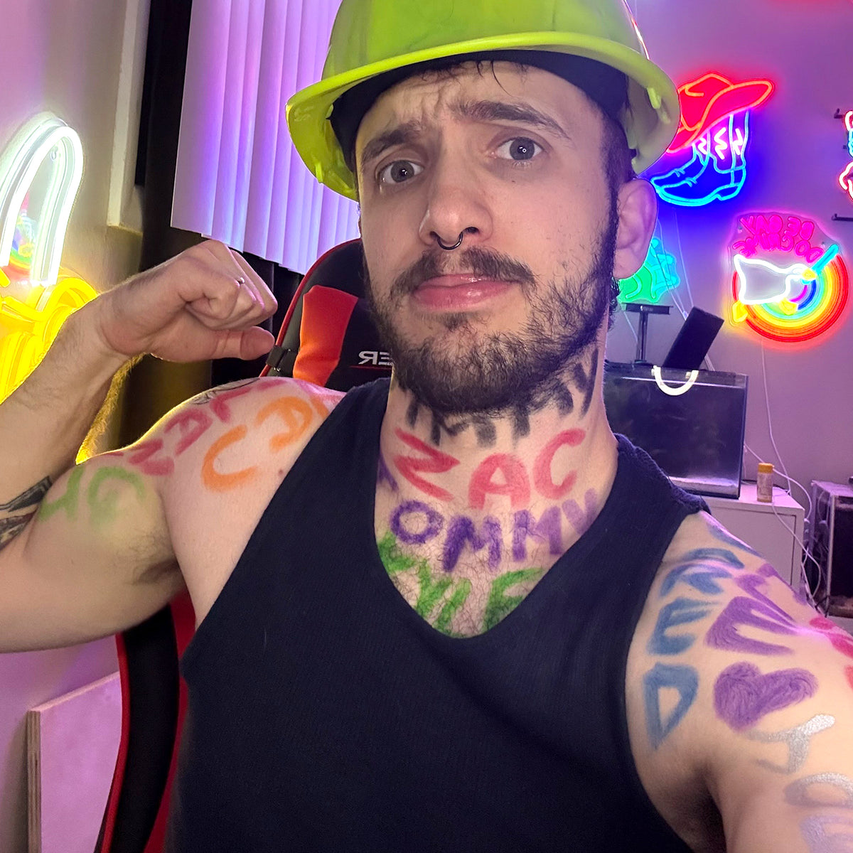 Handyman Zlat flexing arm with 'ZAC OMMY' text on neck and colorful body paint.