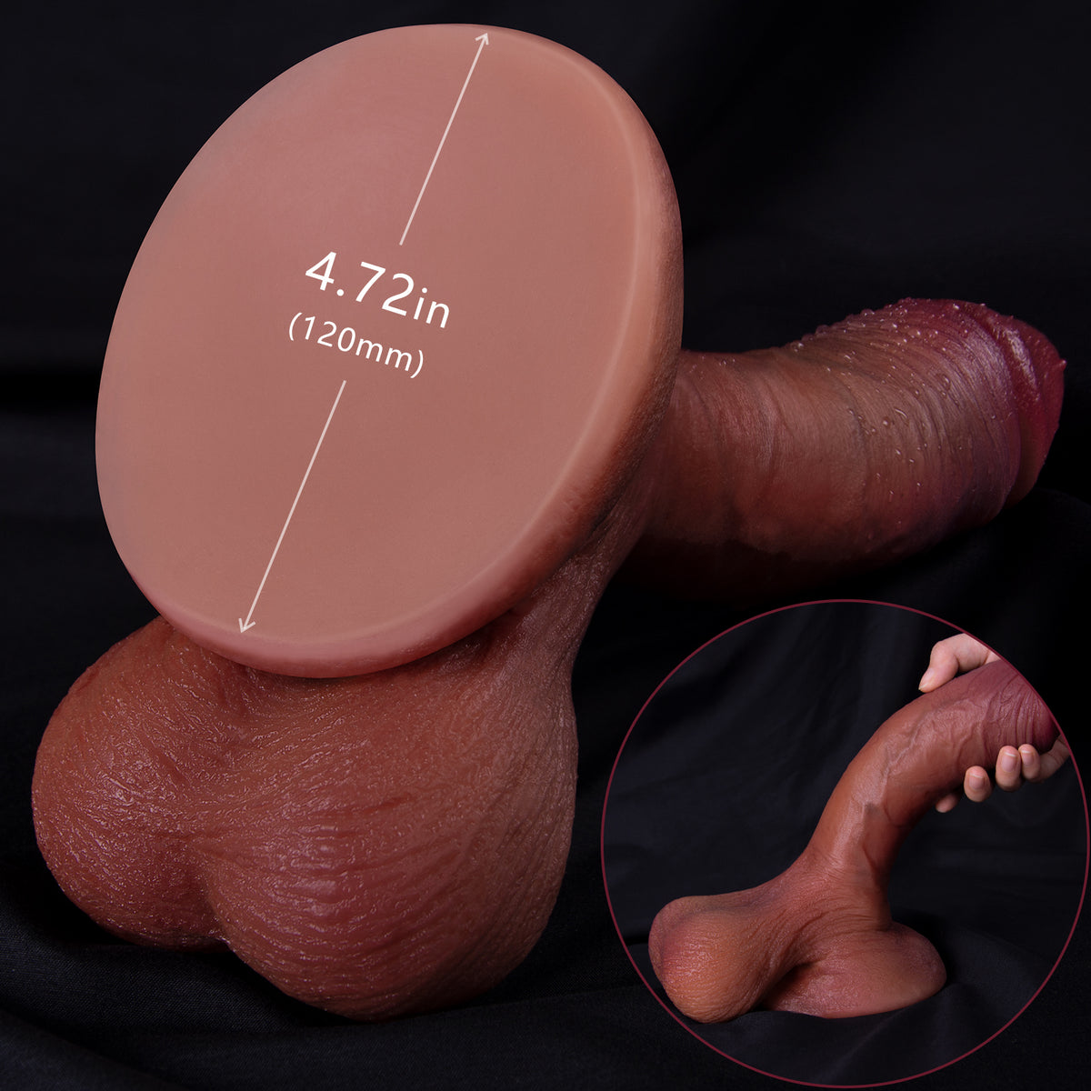 A dildo and hand holding a dildo base on a black background.