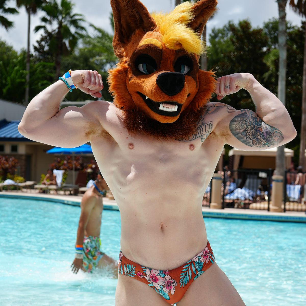 Muscular hyena fursuit man flexing by pool, showcasing HIMBOHYENA replica dildo replica.