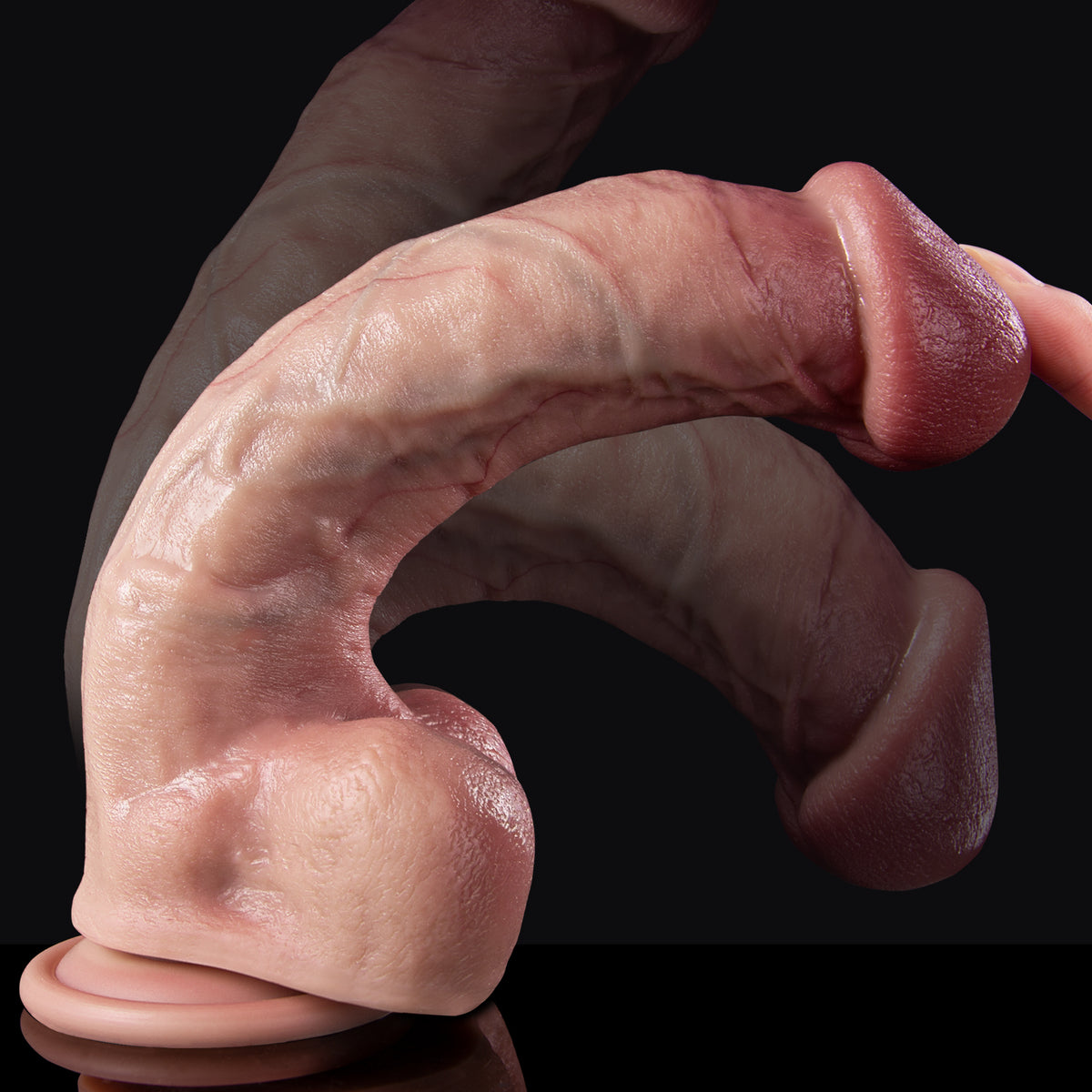 A hand is holding a finger shaped fake skin on black background.
