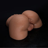 A baby doll with wet skin lying on a black surface.